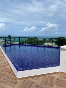 a swimming pool on the roof of a building at Maraca Beach in Porto De Galinhas