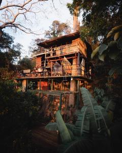 a tree house with a deck and chairs on it at The Treehouse in Granada