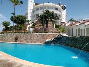 a swimming pool in front of a building at Sierra 3 in Acapulco