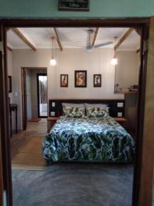 a bedroom with a large bed in a room at Lebombo Wattle Cottage - Forest 1 in Hluhluwe