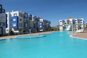 a swimming pool in front of some apartment buildings at Kariat Cabo - Cabo Negro 32 in Cabo Negro