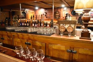 a bar with wine glasses and bottles of alcohol at Silver Horseshoe Inn in Saint Anthony