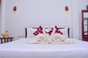 Postel nebo postele na pokoji v ubytování Villa Araliya