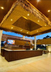 a lobby with a bar with a tv in it at Kambaniru Beach Hotel and Resort in Waingapu