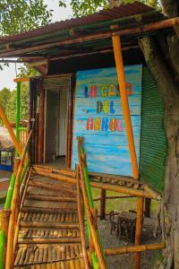 a small house with a sign on the side of it at Room in Lodge - Tree House Finca La Floresta Verde in Rizaralda