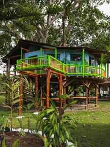 a tree house with a deck on top of it at Room in Lodge - Tree House Finca La Floresta Verde in Rizaralda