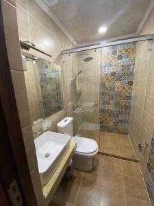a bathroom with a toilet and a shower and a sink at Grand Vizir Hotel in Khiva