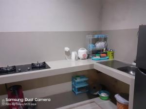 a kitchen with a sink and a counter top at Samadi Villa Batu in Batu