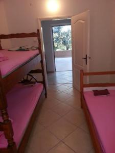 a room with two bunk beds and a door at Apartments Nada in Utjeha