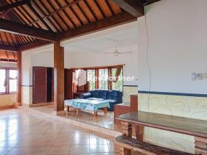 a living room with a couch and a table at Nando House in Ubud