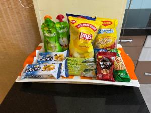 a shelf with snacks and other food items on it at Serenity 1BHK apartment, Alibag in Alibaug