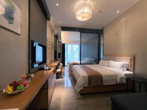 a hotel room with a bed and a television at Vaperse Hotel in Guangzhou