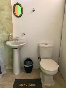 a bathroom with a toilet and a sink at Room in Guest room - Room with 2 double beds number 14 in Rizaralda