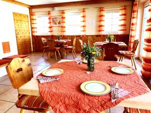 uma sala de jantar com uma mesa com pratos e cadeiras em Kraftplatz Waldzell 