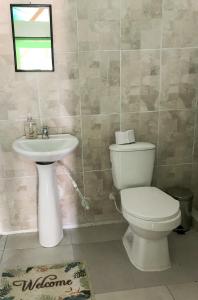 a bathroom with a toilet and a sink at Room in Guest room - Room with 1 double bed and 2 single beds Number 8 in Rizaralda