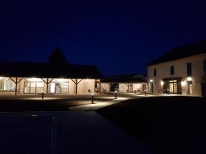 a building with lights in front of it at night at La Pause Ô Logis in Saint-Laurent-du-Jura