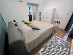 a bedroom with a bed and a couch and a rug at FLEXIHOME sk - Design City - top Location close city centre - big squared in Košice