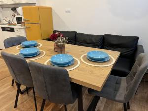 a dining room table with blue dishes on it at FLEXIHOME sk - Design City - top Location close city centre - big squared in Košice