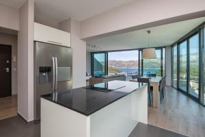 an open kitchen with a large island with a counter top at Green Hill Penthouse apartment in Korčula