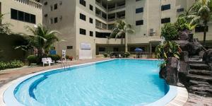a large swimming pool in front of a building at Pangkor Coralbay Resort Room 208 apartment in Pangkor