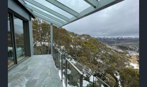 a balcony of a house with a view of the mountains at Snow Ski Apartments 30 in Falls Creek