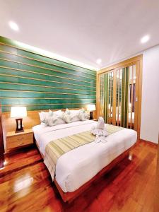 a bedroom with a large white bed in a room at Aonang Phu Dahla Private Pool & Sea View - SHA Plus in Ao Nang Beach