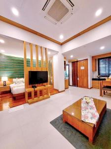 a large living room with a couch and a tv at Aonang Phu Dahla Private Pool & Sea View - SHA Plus in Ao Nang Beach