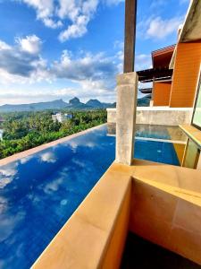 a view of a pool from a house with a bench at Aonang Phu Dahla Private Pool & Sea View - SHA Plus in Ao Nang Beach