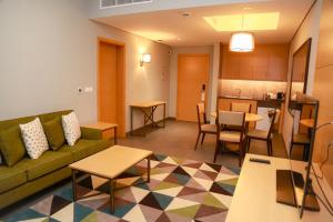 een woonkamer met een bank en een tafel bij Ayla Ibri Hotel in Ibri