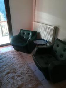 a living room with two chairs and a rug at Breakfast & Snacks, 2bedrooms 2bathrooms House in Kato Zachlorou
