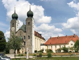 a building with two towers with a clock on it at Ferienwohnungen Herbst in Obing