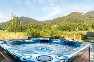 a hot tub in the backyard with mountains in the background at Ferienhaus Hohenaschau in Aschau im Chiemgau