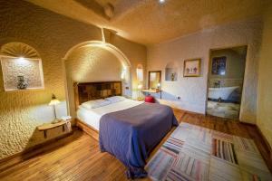 a bedroom with a large bed in a room at Seki Cave Hotel, Wake Up to Hot Air Balloons in Göreme