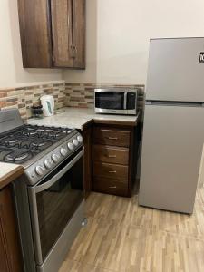 a kitchen with a stove and a refrigerator at Beautiful 1and 2 Bed Apartment in Scarborough in Scarborough