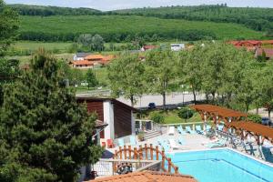 a view of a resort with a swimming pool at FŰZFA VENDÉGHÁZ in Demjén