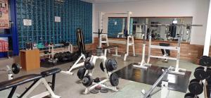 a gym with a bunch of equipment in a room at Hotel Kreator-Sport in Krakow