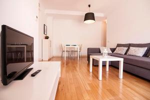 a living room with a couch and a table at Casas FreshApartments in Málaga