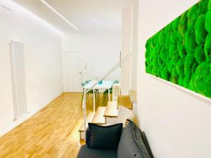 a living room with a green painting on the wall at Nima Oberdan House in Perugia