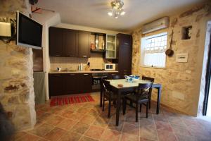 a kitchen with a table and chairs in a room at Le Case Dello Zodiaco albergo diffuso in Modica +16 photos