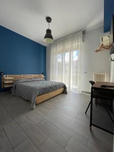 a bedroom with a bed and a blue wall at Il Covo degli Arditi B&B in Potenza