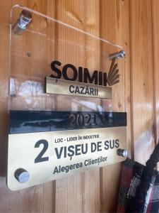 a sign on a wooden wall with a sign on it at Gradina Lu' Ion - Adults Only in Vişeu de Sus