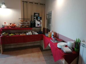 a restaurant with two red tables with food on them at La Rocca dei Borboni in Santa Domenica Talao
