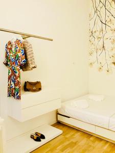 a room with a bed and a shirt and shoes at Nima Oberdan House in Perugia