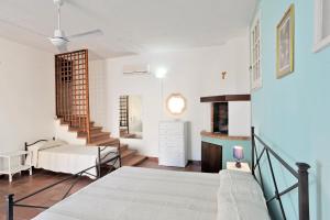 a bedroom with a bed and a staircase in a room at La Capasa B&B in Sannicola