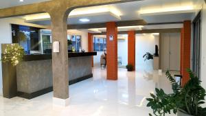 an office lobby with columns and a reception counter at GUINZA in Balneário Camboriú