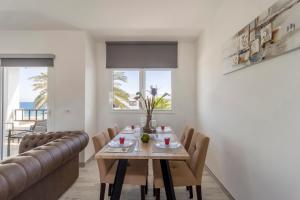 a dining room with a table and chairs at Costa Luz Sirens Beach in Los Pocillos +40 photos