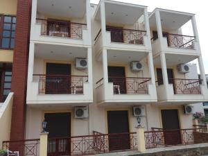 an apartment building with balconies on the side of it at Hotel Kosmas in Sarti