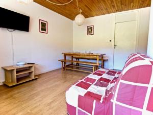 a living room with a couch and a table at Studio Chamrousse, 1 pièce, 4 personnes - FR-1-340-47 in Chamrousse