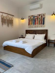 a bedroom with a large bed with white sheets at Moya Urla Butik Otel in Izmir