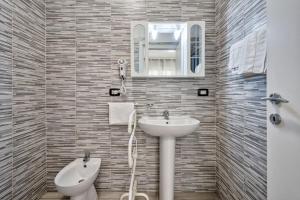 a bathroom with a sink and a toilet at Venice Pink House in Marghera